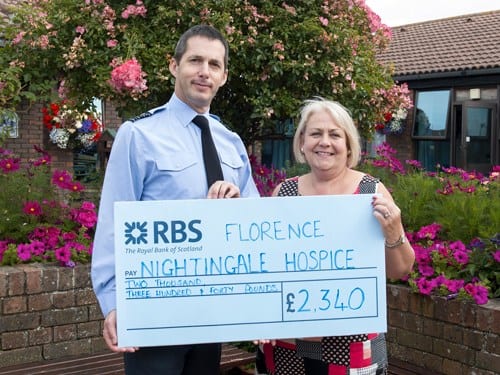 Station Commander and Sue Jenkins with cheque. Crown copyright.
