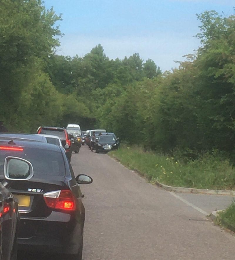 Parking pressure: the holiday weekend scene in a narrow country lane close to a country park